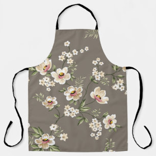 Delantal flores crema adorables con un patrón de hojas verd