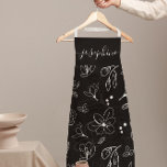 Delantal Linearto floral blanco negro moderno personalizado<br><div class="desc">Aumente su estilo de cocina con este moderno Apron personalizado de arte floral blanco negro. Con un diseño elegante y minimalista de líneas florales negras y blancas, este delantal aporta elegancia y sofisticación a cualquier experiencia culinaria o de cocción. Personalizar con tu nombre, haciéndolo el regalo personalizado perfecto para panaderos,...</div>