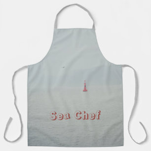 Delantal Mar de invierno tranquilo y faro rojo