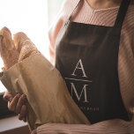 Delantal Monograma Apron personalizado negro<br><div class="desc">Cocine con estilo con este Monograma Negro Personalizado Apron. Con un diseño negro elegante y un monograma de personalizable, este delantal aporta un toque de sofisticación a cualquier cocina. Fabricado con materiales duraderos y de alta calidad, ofrece confort y protección, lo que lo hace perfecto para cocineros aficionados y profesionales....</div>