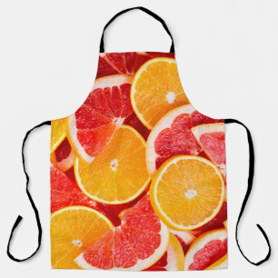 Delantal Naranja maduro fresco y fondo de pomelo