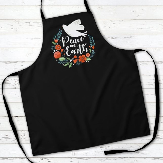 Delantal Navidades Paz en la Tierra (a stylish Christmas holiday apron with the words, peace on earth, and a dove.)
