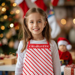 Delantal Nombre de Navidades de la franja de caña de candy<br><div class="desc">Celebra a los Navidades con estilo con un delantal estriado de caramelo festivo; personalizar con nombre,  o claro. La banda roja también es editable.</div>