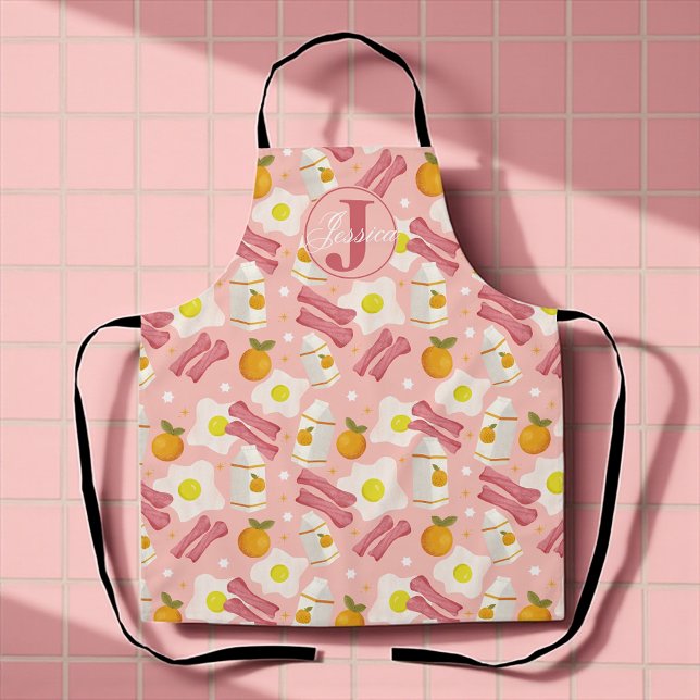 Delantal Patrón de desayuno retro personalizado (Whimsical pink apron with fried eggs, bacon, milk, and oranges for sunny breakfast vibes.)