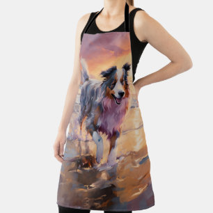 Delantal Perro pastor australiano arenoso en la puesta de s