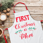 Delantal Primera Navidad como mamá<br><div class="desc">Este delantal de los Navidades es perfecto para celebrar la primera Navidad como madre. La frase dice "Primera Navidad como mamá" con letras rojas modernas en un fondo blanco.</div>