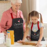 Delantal Red Black Christmas Baking Crew Custom Family<br><div class="desc">Make holiday baking even more memorable with these personalized Christmas Baking Crew aprons in festive red, white on black! Perfect for the entire family, these aprons feature your custom family name, a fun Santa hat icon, and modern, gender-neutral typography that everyone will love. Create a new holiday tradition with a...</div>