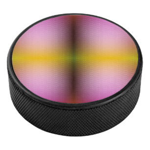 Disco De Hockey Un altavoz redondo con un rosa, amarillo y verde 