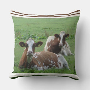 Dos vacas blancas-marrones almohadas