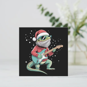 Dragón barbudo de Navidad tocando la guitarra músi