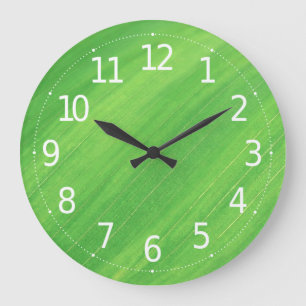 El verde simple deja el reloj de pared del primer