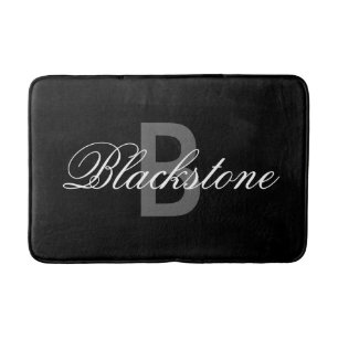 Elegante alfombra de baño con monograma negro para