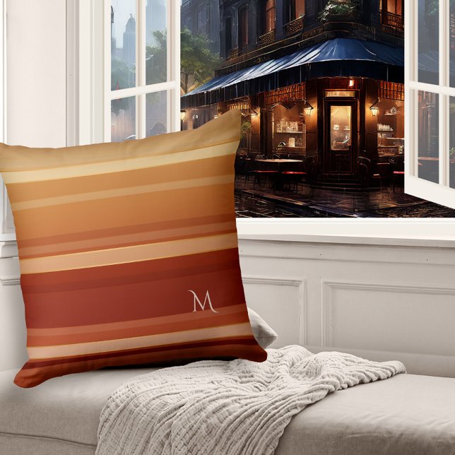 Elegante almohada rayada de crema borgoñona (Pillow featuring an elegant striped pattern in warm burgundy, coffee and creamy chocolate colors)