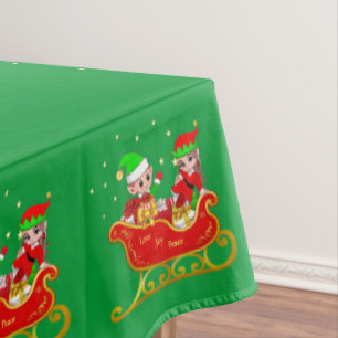 Elfos de Navidad lindos en trineo sobre mantel ver