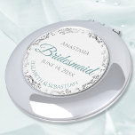 Espejo Compacto Bridesmaid Gift Elegant Teal & Silver Lace<br><div class="desc">These compact mirrors are designed to give as favors to the bridesmaids in your wedding party. They feature a simple yet elegant design with a white background, teal or turquoise colored script lettering, and a silver gray faux foil floral lace border. Perfect way to thank your bridesmaids for being a...</div>