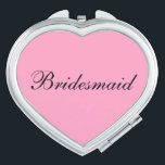 Espejo compacto de la dama de honor<br><div class="desc">Espejo compacto mostrado en forma de corazón con un color de fondo rosado con texto de la dama de honor en negro. Personalizar este artículo o compra tal cual.</div>