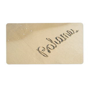 Etiqueta Bahamas seña tallada en la arena de la playa