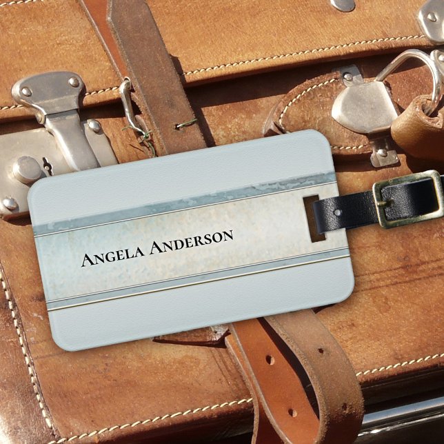 Etiqueta de equipaje con estilo de arena y playa d (Luggage tag showing an abstract elegant design in sand and dusty blue colors, inspired by the beach)