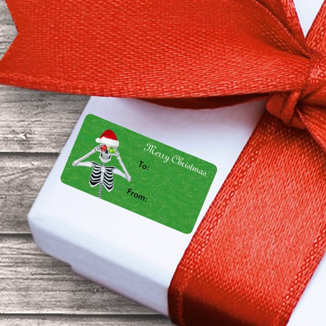 Etiqueta Feliz Navidad Skeleton Ornament Ojos Oro verde (Christmas skeleton ornament eyes Santa hat on green gift tag sticker label.)