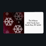 Etiqueta Festive Snowflakes<br><div class="desc">A pretty design featuring snowflakes in various shapes and sizes on a cranberry red background. Elegant swirls accent it. Customize with your address as desired.</div>