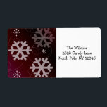 Etiqueta Festive Snowflakes<br><div class="desc">A pretty design featuring snowflakes in various shapes and sizes on a cranberry red background. Elegant swirls accent it. Customize with your address as desired.</div>