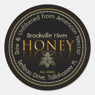 Etiqueta local de miel negra y dorada con abeja
