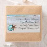 Etiqueta Starfish Beach Christmas Wide Return address label<br><div class="desc">Starfish and ornament decorated beach address labels. These wide labels will hold up to 5 lines of text in elegant printed font style, which is easy to read. Smooth beach sand and waves lapping at the shore is the image behind the design. Choose this size or shipping label size. Remove...</div>