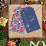 Etiquetas Para Regalos Mínimo Poinsettia Blue Santa Merry Christmas<br><div class="desc">Este diseño simple y mínimo presenta mi poinsettia azul pálido dibujado a mano sobre un fondo azul oscuro en el frente y un patrón de Santa y de poinsettia roja tradicional en la parte posterior para una vibra clásica que evoca la nostalgia de los Navidades del pasado mientras que los...</div>