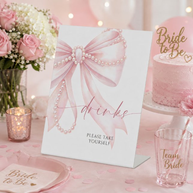 Expositor En L Bebidas con Lazo Rosa Perla  (Pearl pink bow drinks sign displayed at a bridal shower with pink decor and cake)