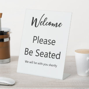 Expositor En L Bienvenido Por Favor Tome Asiento Escritura Blanca