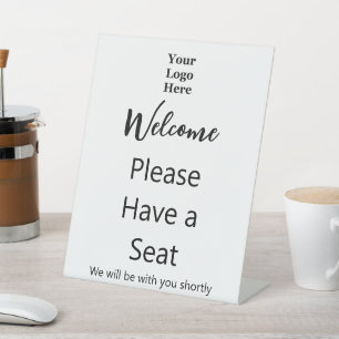 Expositor En L Bienvenido Por favor, tome un asiento y su logotip