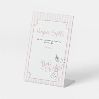 Expositor En L Uno de Trinidad se acerca al Rótulo Diaper Raffle