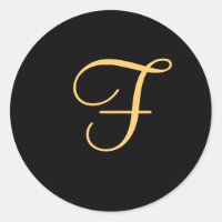 "F" inicial de color dorado sobre pegatina de mono