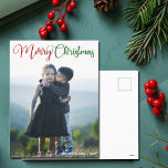 Feliz Navidad Elegante foto de tipografía verde ro<br><div class="desc">Elegante postal navideña con hermosa tipografía cursiva en rojo y verde. Estas modernas postales fotográficas familiares de vacaciones cuentan con un precioso guión y tu nombre en blanco sobre la imagen completa de la sangre.</div>