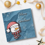 Feliz Navidad, hombre de nieve con ropa de punto<br><div class="desc">Un pequeño y hermoso muñeco de nieve con ropa de punto blanco y rojo en un papel azul. Perfecto para desear feliz Navidad a los más pequeños.</div>