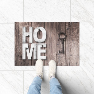 Felpudo Las llaves de la casa de Doormat en la madera fals