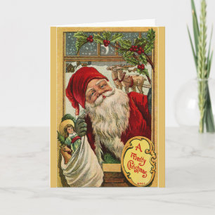 Festiva Papá Noel en la ventana con tarjeta de felicitació