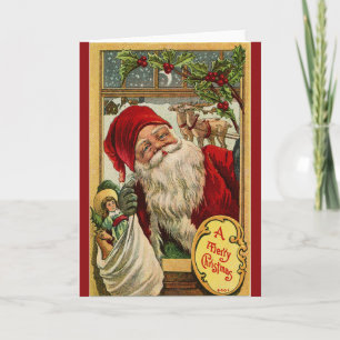 Festiva Santa en la ventana con tarjeta de felicitación de