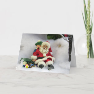 Festiva Santa toma una tarjeta de saludo tambaleante