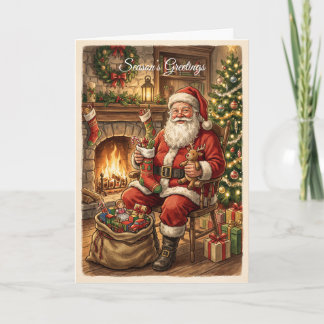 Festiva Tarjeta de vacaciones de Papá Noel junto al fuego