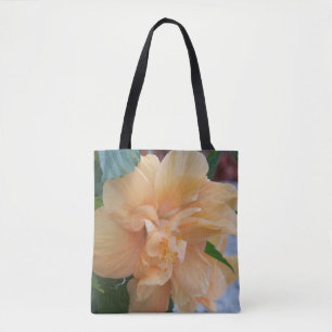 Flor de hibisco naranja en una bolsa de tote