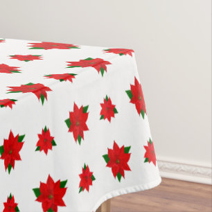 Flores de Poinsettia de Navidad sobre mantel blanc