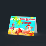 Florida Feliz Navidad Santa y Flamingo Beach<br><div class="desc">Esta tarjeta de felicitación de Navidad de Feliz incluye Santa Cláusula en una playa de Florida. Se está relajando disfrutando del sol, las palmeras, su pipa y un gracioso flamenco rosa usando un sombrero de Santa y corona. Saludos internos ~ "Los deseos más cálidos de nuestro paraíso de vacaciones a...</div>