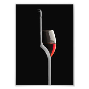 Foto Copo de vino rojo elegante y botella. Fondo negro