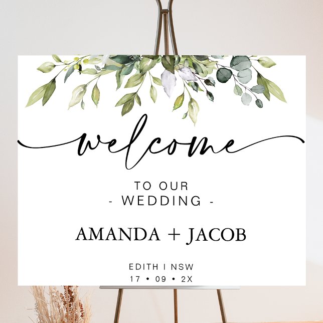 Foto Signo de bienvenida del Boda de caligrafía fológic (Foliage of greenery wedding welcome sign featuring a modern calligraphy heading with swash tails.)