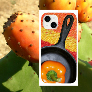 Funda iPhone 16 Pepper naranja en una sartén de fritura negra, una