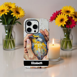 Funda iPhone 16 Pro Mano sosteniendo un pájaro pintado vibrante