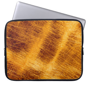 Funda Para Portátil Escrates sobre un fondo metálico de oro. abstracto