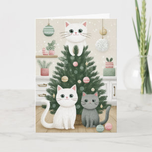 Gatitos en la tarjeta del árbol de Navidad