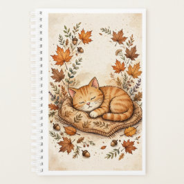 Gato acogedor en el planificador de otoño